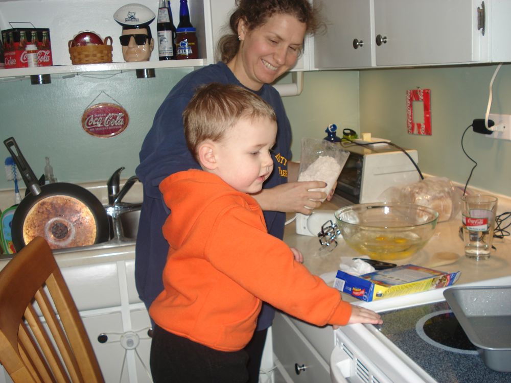 Evan helping Amy in the kitchen