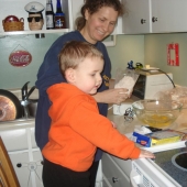 Evan helping Amy in the kitchen