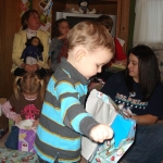 Evan opening presents  with cousin KT